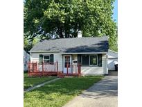 Charming single-story home featuring a red porch, well-maintained lawn, and a detached garage at 728 Lonsvale Dr, Anderson, IN 46013