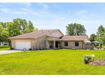 Charming stone home with a well-maintained lawn and inviting curb appeal at 8111 Timberwood Dr, Plainfield, IN 46168