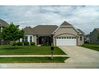 Well-maintained home with attached two car garage, brick facade, and a landscaped front yard at 8732 Wicklow Way, Brownsburg, IN 46112