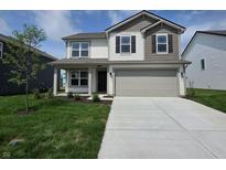 Charming two-story home featuring a two-car garage and a well-manicured lawn at 11302 N Quillow Way, Monrovia, IN 46157
