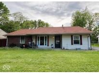 Charming single-story home with well-maintained lawn and inviting front porch seating at 128 Coronado Rd, Indianapolis, IN 46234