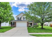 Charming two-story home featuring a well-manicured front yard and an attached two-car garage at 13209 Westwood Ln, Fishers, IN 46038