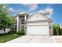 Charming two-story home featuring a two-car garage, brick facade, and well-manicured lawn on a sunny day at 14030 Avalon East Dr, Fishers, IN 46037