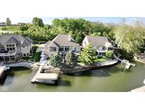 Waterfront home with a private dock and boat lift on a tree-lined lot at 14035 Stone Key Way, Fishers, IN 46040