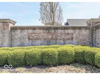 Brick sign for Brighton Estates with manicured bushes in front at 1476 Anon Ct, Greenwood, IN 46143