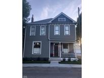 Charming two-story home with gray siding, white trim, and a welcoming front porch at 1512 Bellefontaine St, Indianapolis, IN 46202