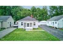 Charming bungalow-style home with fresh exterior paint and lush front yard at 1517 Wallace Ave, Indianapolis, IN 46201