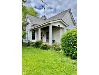 Charming two-story home with a covered front porch, mature landscaping, and traditional architectural details at 1806 Union St, Columbus, IN 47201