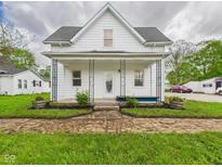 Charming home featuring a covered front porch and well-maintained front yard landscaping at 225 S Carthage Rd, Charlottesville, IN 46117