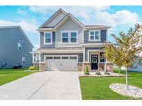Charming two-story home featuring a well-maintained lawn and an attached two-car garage at 3016 Gibbert Ln, Westfield, IN 46074