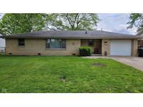 Charming ranch-style home featuring a lush green lawn, brick exterior, and attached one-car garage at 3412 Loral Dr, Anderson, IN 46013
