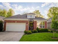 Charming brick home featuring an attached two-car garage and a well-manicured front lawn at 3438 Windy Knoll Ln, Carmel, IN 46074