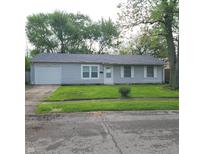 Charming one-story home with a well-maintained lawn and a one car garage at 3453 Payton Ave, Indianapolis, IN 46226