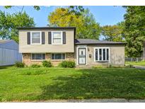 Charming two-story home with a well-maintained lawn and a mix of brick and siding exterior at 3514 Eisenhower Dr, Indianapolis, IN 46224