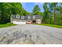 Traditional two-story home featuring a brick entryway, attached garage, and mature trees at 3660 S Conservation Club Rd, Morgantown, IN 46160