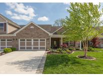Charming brick home with well-manicured lawn, two-car garage, and a welcoming front porch at 4281 Cairo Way, Avon, IN 46123