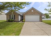 Charming single story brick home with an attached two car garage and well maintained lawn at 4615 Copper Grove Dr, Indianapolis, IN 46237