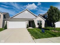 Charming brick home with a well-manicured lawn, two-car garage and beautiful curb appeal at 5313 Brandywine Dr, Whitestown, IN 46075