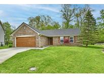 Charming brick home with a well-maintained lawn and attached garage at 5611 Burning Tree Ct, Indianapolis, IN 46239