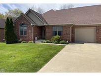 Charming brick home with a well-manicured lawn and attached one car garage at 636 Mallards Xing # 2-A, Martinsville, IN 46151