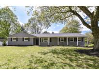 Charming single-story home with manicured front lawn and lovely curb appeal at 7118 Mikesell Dr, Indianapolis, IN 46260