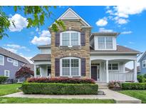 Charming two-story home with a stone facade and landscaped front yard at 7614 Bishops, Zionsville, IN 46077
