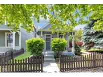 Charming home with manicured landscaping, picket fence, and covered front porch at 767 Fletcher Ave, Indianapolis, IN 46203