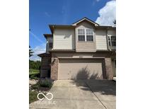 A delightful two-story home with a two-car garage, brick accents, and lush landscaping at 8002 Windham Lake Way # 33, Indianapolis, IN 46214