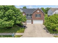 Beautiful brick two-story home with a well-manicured lawn and a spacious two-car garage at 8316 Thorn Bend Dr, Indianapolis, IN 46278