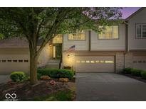 Charming townhome showcasing a well-maintained front yard and inviting entrance with a garage at 9317 Muir Ln, Fishers, IN 46037