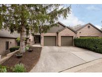 Charming brick home featuring a two-car garage and well-maintained landscaping, creating inviting curb appeal at 11319 Shoreview Ln, Indianapolis, IN 46236