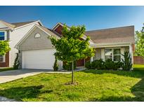Charming home featuring an attached two-car garage, brick accents, and a well-maintained lawn with mature landscaping at 1221 Danielle Rd, Lebanon, IN 46052