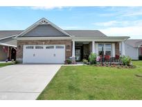 Charming brick home featuring a two-car garage and a welcoming front porch at 1401 Blackthorne N Trl, Plainfield, IN 46168