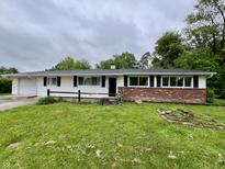 Charming ranch-style home featuring brick accents, black shutters, and a well-maintained lawn at 1949 Shenandoah Pl, Indianapolis, IN 46229