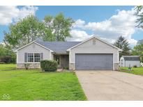 Charming ranch-style home with an attached two-car garage, a well-manicured lawn, and professional landscaping at 2444 S Brandywine Ct, Greenfield, IN 46140