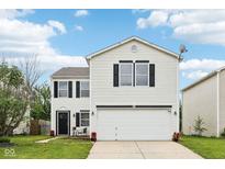 Charming two-story home featuring a large garage, manicured lawn, and classic white siding at 2545 Harvest Moon Dr, Greenwood, IN 46143