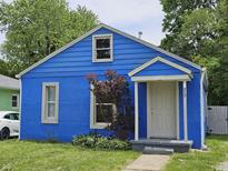 Charming blue bungalow featuring a cozy front entrance and well-maintained lawn at 2737 S Roena St, Indianapolis, IN 46241