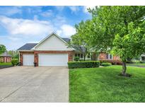 Charming brick and siding home with a well-manicured lawn and attached two-car garage at 3996 Brockton Manor N Dr, Greenwood, IN 46143