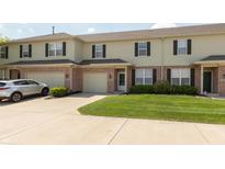 A home's exterior showcases its well-manicured lawn, a car in the driveway and attached garages at 4104 Bullfinch Way, Westfield, IN 46062