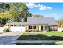 Charming single-story brick home with well-maintained landscaping and an attached two-car garage at 51 Wilson Dr, Carmel, IN 46032