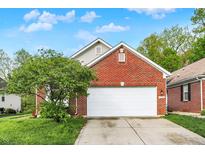 Charming brick home with a well-maintained lawn and attached two-car garage at 5348 Pelham Way, Indianapolis, IN 46216