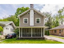Charming two-story home featuring a screened-in front porch and classic architectural details at 5829 Broadway St, Indianapolis, IN 46220
