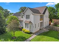 Charming two-story home featuring a well-manicured lawn and attractive stone walkway at 608 East 21St St, Indianapolis, IN 46202