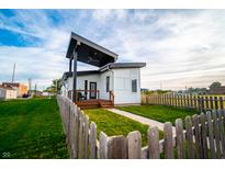 Striking modern home features a stylish covered porch and well-manicured lawn at 1112 Spann Ave, Indianapolis, IN 46203
