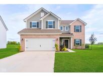 Charming two-story home with a well-manicured lawn, a two-car garage, and beautiful brick and siding accents at 17951 Paula Walk, Westfield, IN 46074