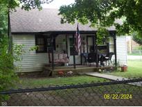 Charming home featuring a cozy front porch with swing, perfect for relaxing and enjoying the outdoors at 3057 S Rybolt Ave, Indianapolis, IN 46241