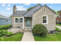Charming stone-clad home featuring a quaint front entrance and well-maintained landscaping at 311 Duffey St, Plainfield, IN 46168