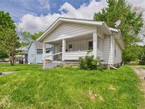 Charming home with a covered front porch and well-maintained lawn at 510 E 23Rd St, Anderson, IN 46016