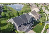 Aerial shot showcases the house's roof, landscaping, and neighborhood pond at 6064 Bartley Dr, Noblesville, IN 46062