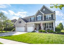 Charming two-story home with manicured lawn, three car garage and welcoming front porch at 6064 Bartley Dr, Noblesville, IN 46062